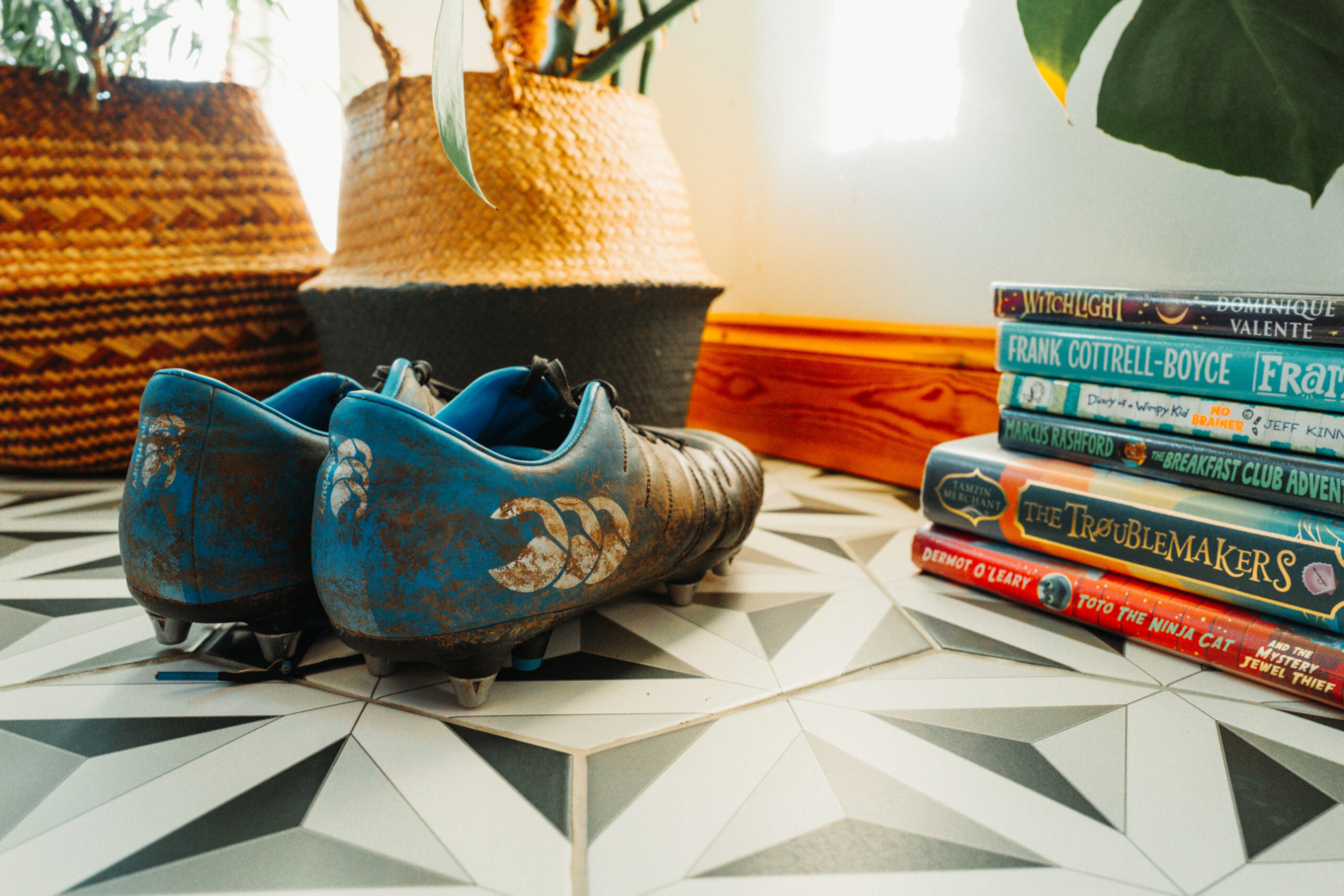 Muddy football boots in a hallway